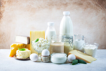 Fototapeta na wymiar Fresh dairy products, milk, cottage cheese, eggs, yogurt, sour cream and butter on white table
