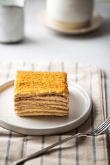 Delicious slice of homemade honey cake on white background.