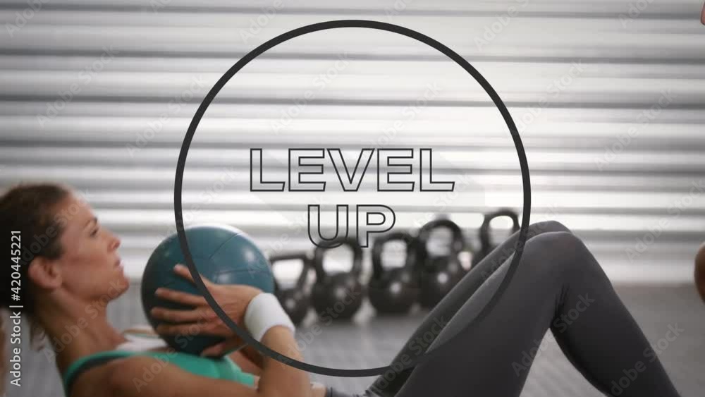 Poster animation of level up text in black circle outline over woman exercising with ball in background