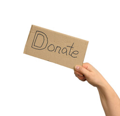 female hand holding a brown piece of cardboard with the inscription donate