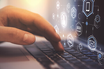 Social network interface on hologram screen and man hand typing on laptop keyboard