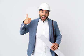 Young architect man with helmet and holding blueprints isolated on white background giving a thumbs up gesture