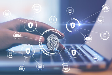 Online payment and biometric identification concept with digital screen with fingerprint and security symbols and laptop with hand