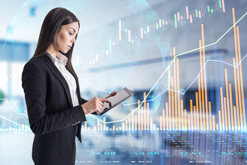 Analysis and analytics concept with digital tablet and businesswoman and growing financial graphs, candlestick and diagram on touch screen background