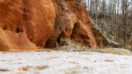Sea cliff with Devonian sandstone outcrops. During the storm, niches and caves were washed away in...