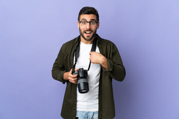 Photographer man over isolated purple background with surprise facial expression