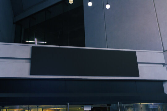 Blank black sign above entrance to the shopping center