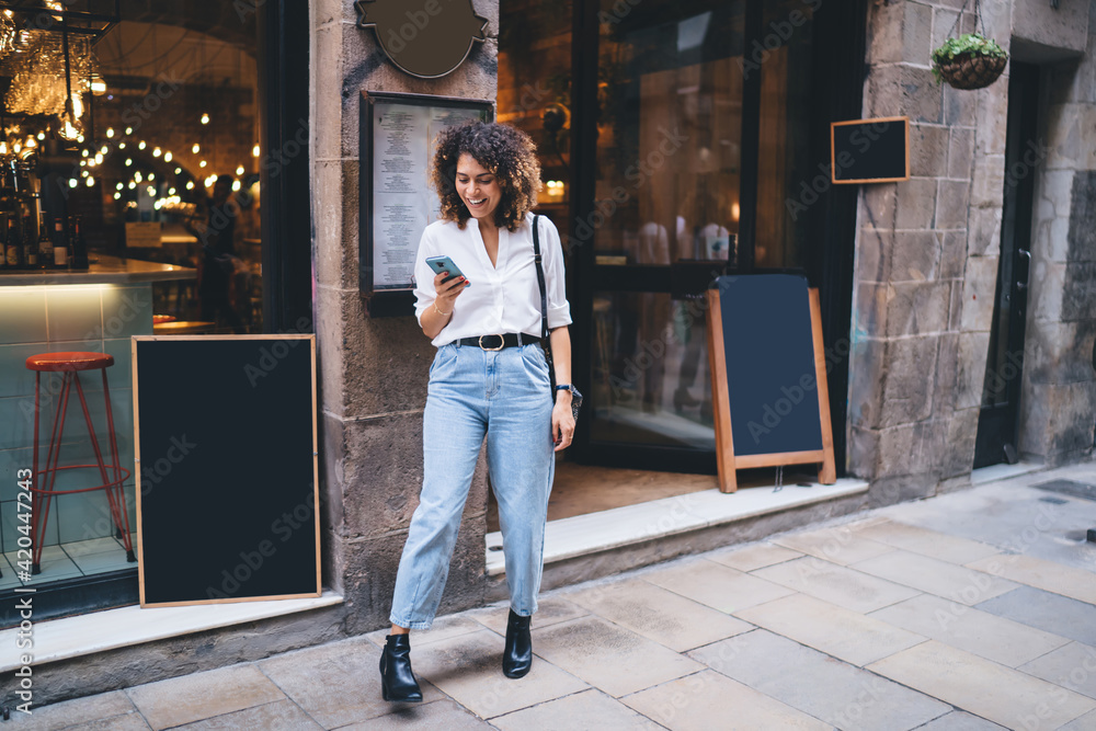 Aufkleber cheerful female traveller using cellular technology for chatting near mockup stand with copy space f