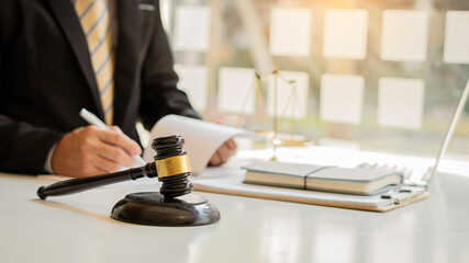 Male attorney advisor or judge advisor concept, having team meetings with clients, legal concepts and hammer attorneys with fair scales on desks in the office.