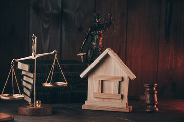 Auction or law concept. Miniature House with judge gavel, scales and lady of justice