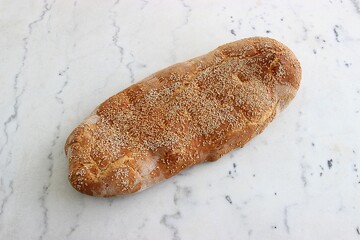 Greek sesame bread of Lagana, traditionally eaten on "Kathara Deftera" in Greece on a white marble table. Selective focus