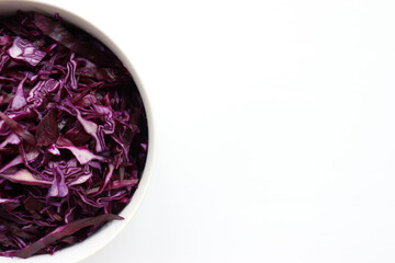 Easy homecooked coleslaw from red cabbage in a bowl on white table background. Top view, copy space. Fresh vegetable salad. Flat lay food. Healthy eating concept
