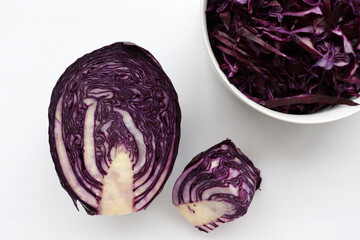 Fototapeta premium Easy homecooked coleslaw from red cabbage in a bowl and ingredients on white table background. Top view, copy space. Fresh vegetable salad. Flat lay food. Healthy eating concept 
