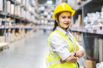 Portrait of asian woman warehouse worker are posing and smiling to the camera in a warehouse