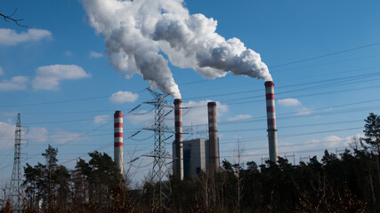 Smoking chimneys of a coal-fired power plant. Made in a sunny day, deep blue skies