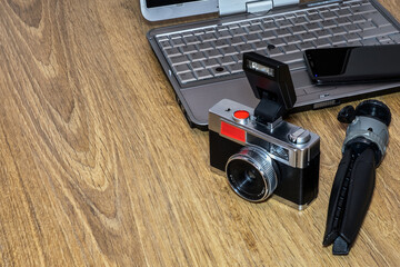 Composition of a laptop, a mobile and an old camera