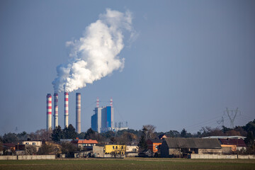 View of a distant coal-fired power plant. Made on a sunny day.