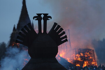 Symbol of Russia: two-headed eagle. Maslenitsa 2021. Traditional national holiday, folk game in...