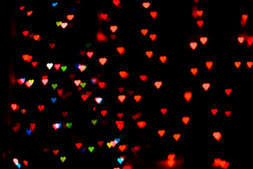 Fototapeta na wymiar abstract background with lights in the shape of hearts