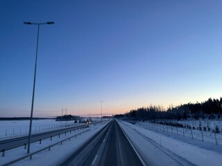 Fototapeta na wymiar Highway with sunrise in Finland