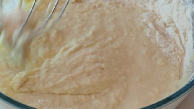 Mixing Batter or dough for banana cake or muffin or pancake. edd eggs Close up, soft focus.