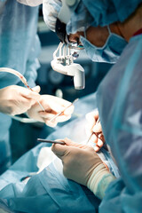 Rhinoplasty men, the surgeons gloved hands hold the instruments during nose surgery. Doctor in...