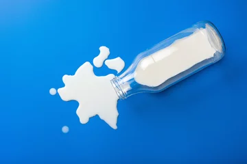 Fotobehang bad milk lactose intolerance allergy. milk bottle splatter. avoid dangerous dairy © Olga Miltsova