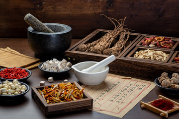 Ancient Chinese medicine books and herbs on the table