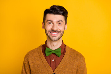 Obraz premium Portrait of handsome satisfied young man toothy smile look camera isolated on yellow color background