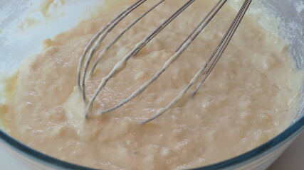 Mixing Batter or dough for banana cake or muffin or pancake. edd eggs Close up, soft focus.
