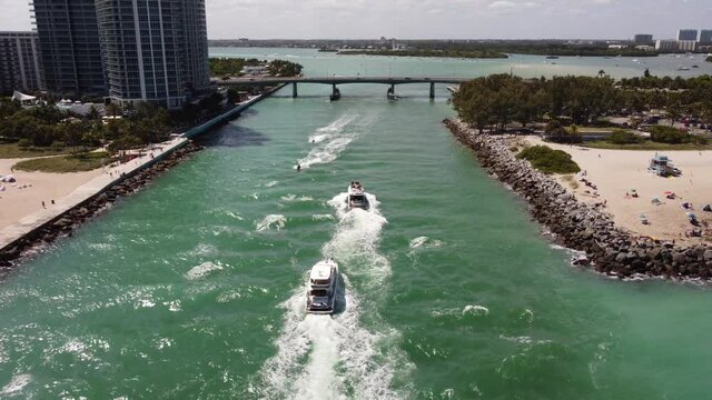 Wavy boats passing under inlet Miami Beach FL footage
