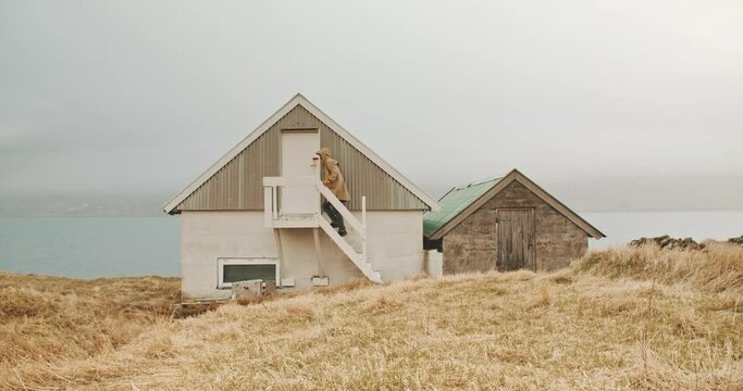 Man walking upstairs of a tiny house 