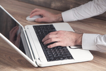 Businessman using laptop in office.