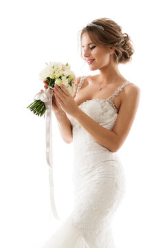Bride Flower Bouquet. Beauty in Wedding Dress holding White Roses. Isolated White