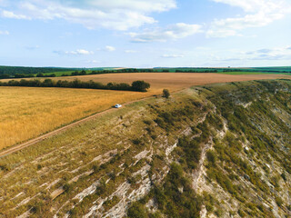 Obraz premium white car driving on top of hill