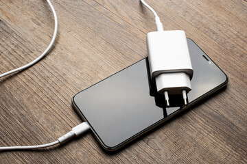 White charger lying on the phone.