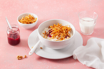 rice pudding with Norwegian brunost traditional brown cheese and raspberry jam