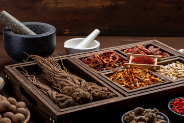 Ancient Chinese medicine books and herbs on the table