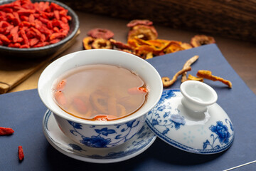 Traditional Chinese health tea and classical medical books on the table