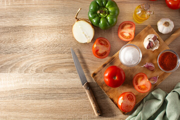 Preparing tomato sauce in the kitchen. Ingredients on the kitchen counter. Top view. Copy space