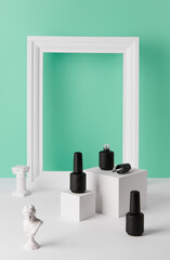 Bottles of nail varnish on podium on turquoise background