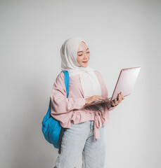 asian muslim student holding laptop in front of white background