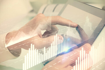 Multi exposure of man's hands holding and using a phone and financial chart drawing. Market analysis concept.