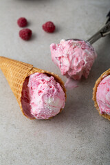 Close up gelato in waffle cone on gray surface