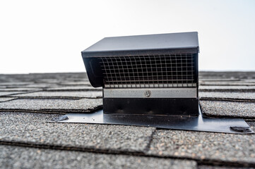 Static vent installed on a shingle roof for passive attic ventilation