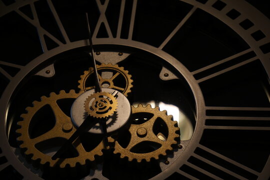 Old watch mechanism in the dark. Clock hands as symbol of time management.