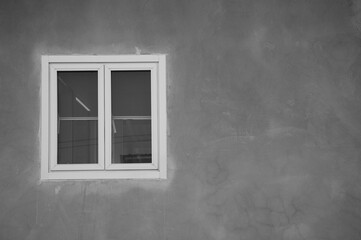 white frame window with grey cement wall background