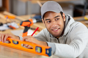 happy craftsman measuring floor level