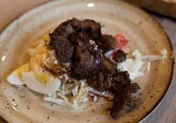 warm salad with chicken liver, cabbage and boiled egg