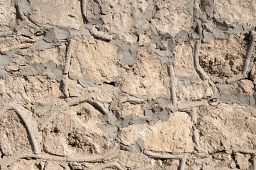 Decorative wall made of natural stone of various shapes and sizes. Interior background